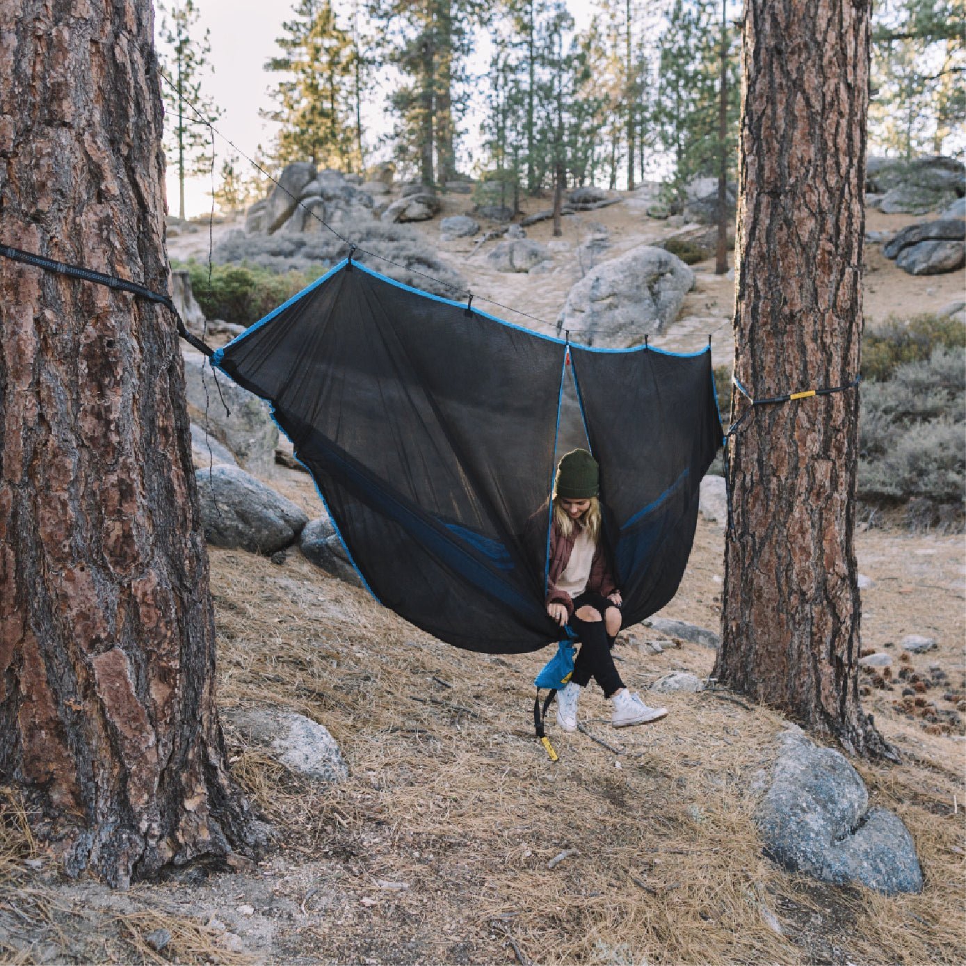 Women in a hammock using a hammock bug net.