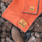 Orange Camping Towel on Rocks