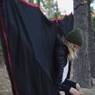 Women in a hammock enjoying nature with a hammock bug net.