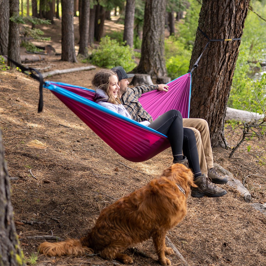Couple enjoying the outdoors in their two person hammock.