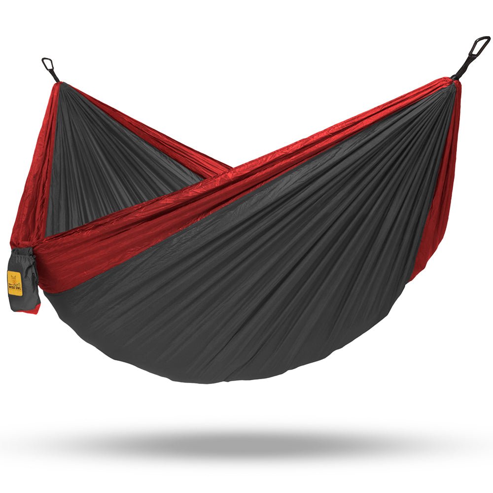 Read a book in a grey two person hammock for some extra room.